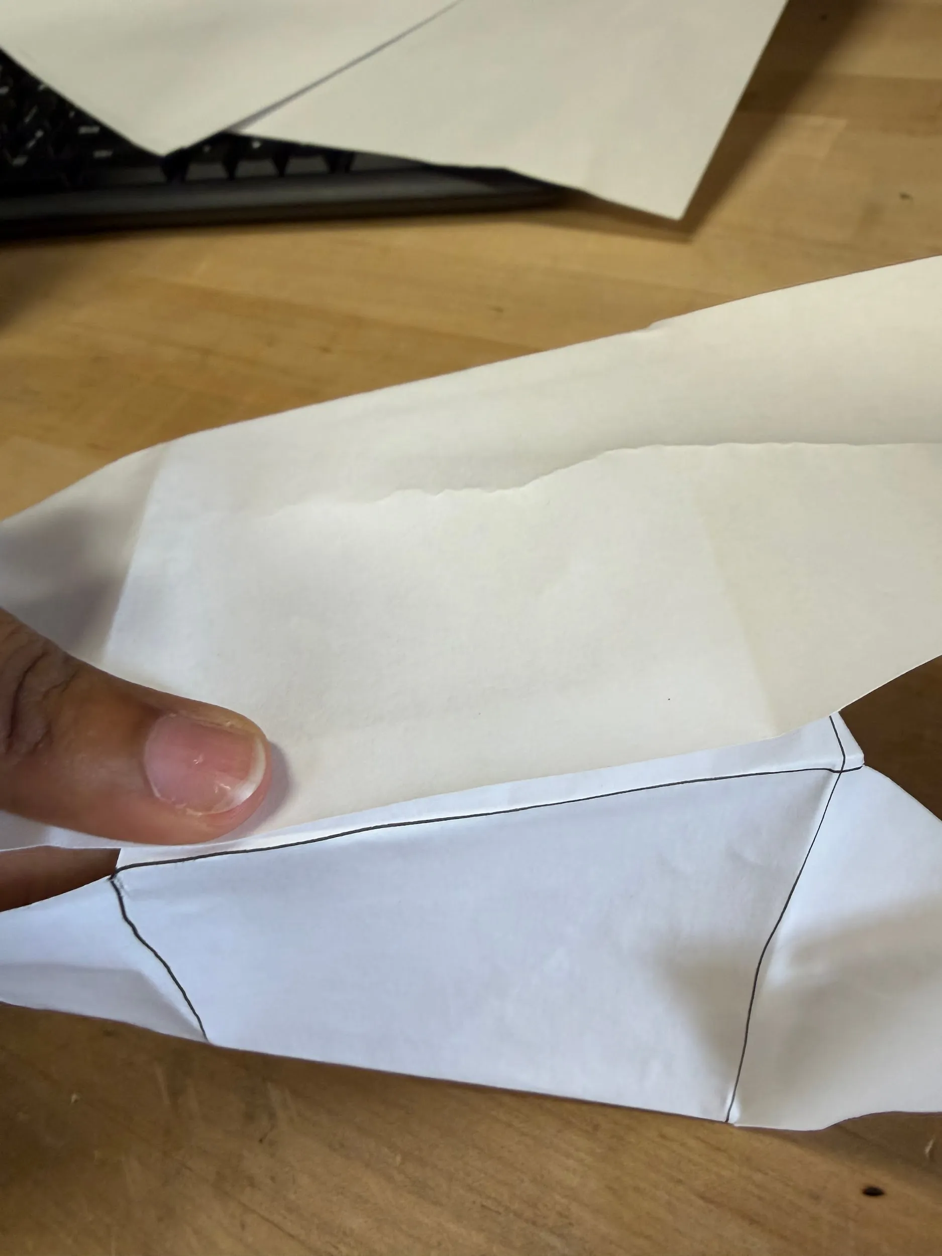 The outer left tab wrapped around and taped to the right piece