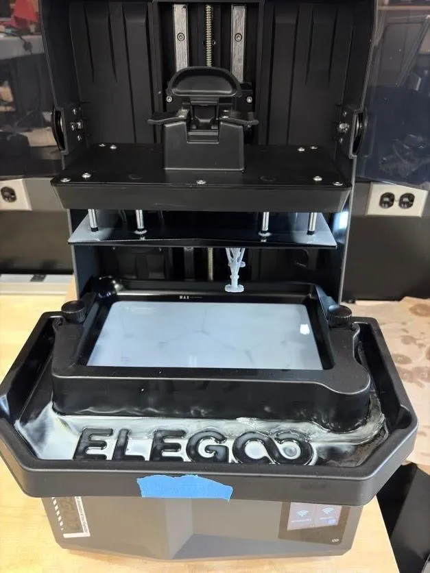 The plastic drip tray fitted around the resin vat inside the printer