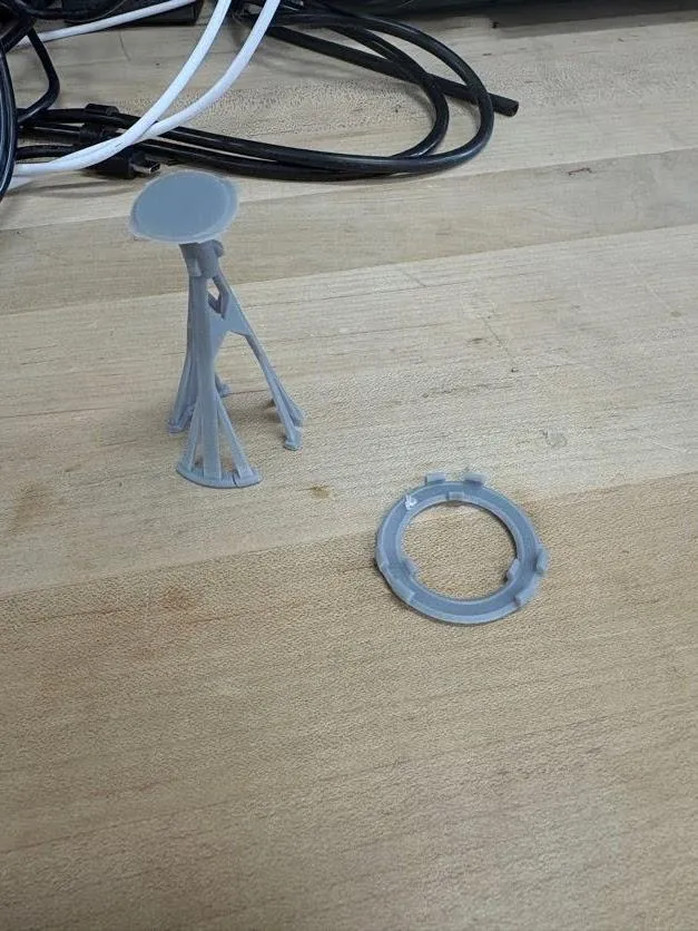A printed stem standing next to a separate printed circle on a bench