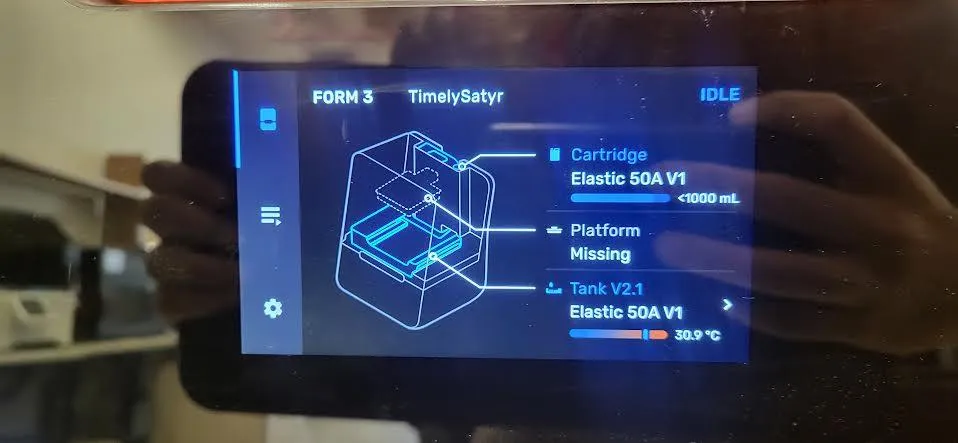Form 3 touchscreen showing the printer named TimelySatyr as IDLE, with Elastic 50A V1 in the cartridge, the platform missing, and Elastic 50A V1 in a V2.1 tank at 30.9 degrees C