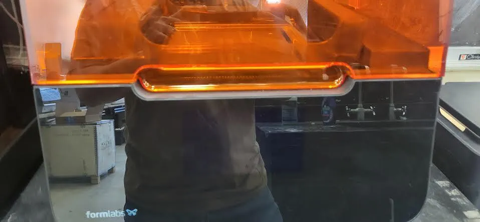 The Form 3 cover open over the resin tank, with the printer awake