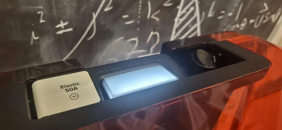 The top of a resin cartridge labelled Elastic 50A V1 seated in the printer, with the vent valve visible